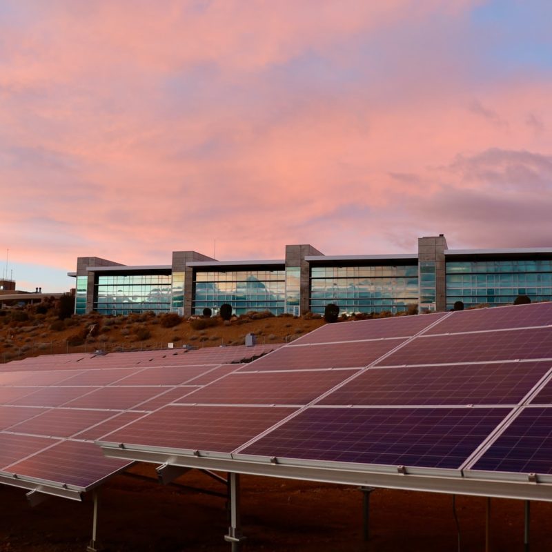 solar panels on brown field under white clouds during daytime